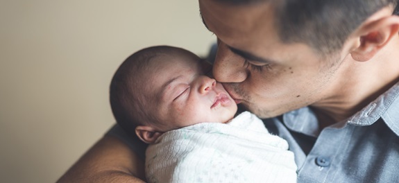 man holding infant child
