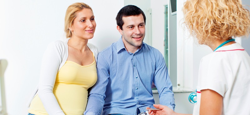 pregnant couple being consulted